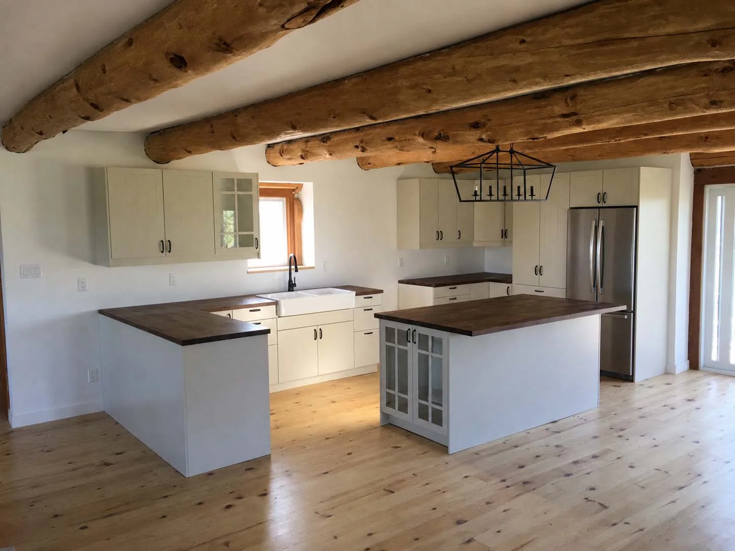 Completed IKEA kitchen with custom-fit panels, island and wood countertops